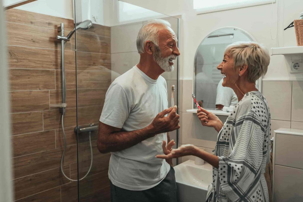 Seniors -  Husband and wife smiling in bathroom